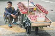 Sweet potatoe street vendor waits for customers in Busan, Republic of Korea.