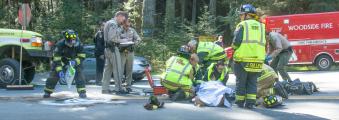 Kings Mountain volunteer fire fighters attend to accident victim assisted by Cal-Fire, Woodside FD and the California Highway Patrol.