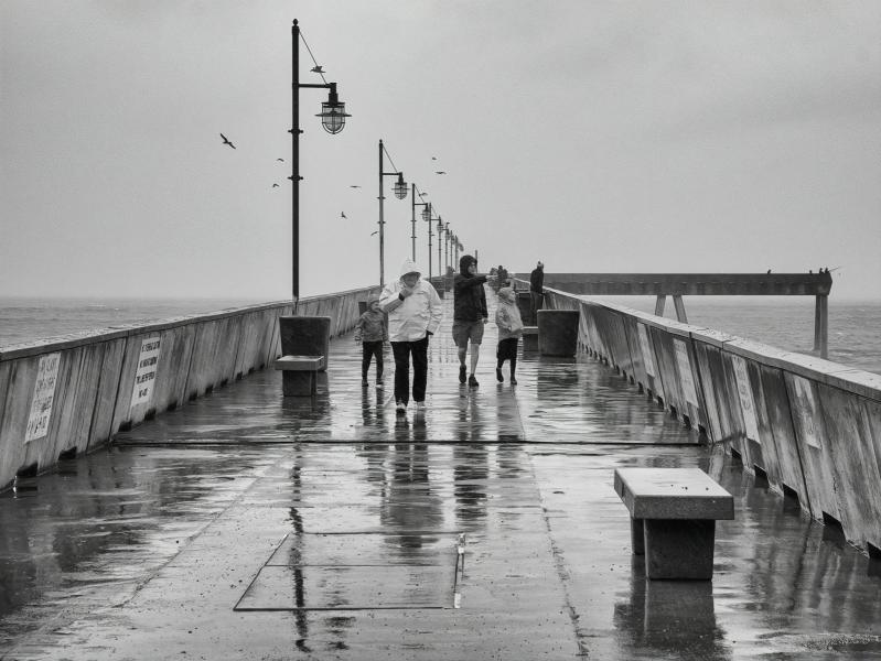 Pacifica Pier Pedestrians on a Rainy Day.