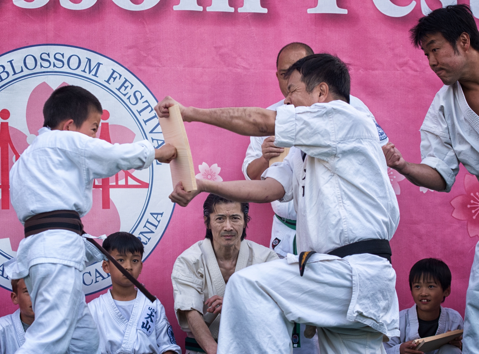 A karate-kid attempts to break a board with his fist at the Cherry Blossom Festival in San Francisco Japantown.  April 13th, 2019.
