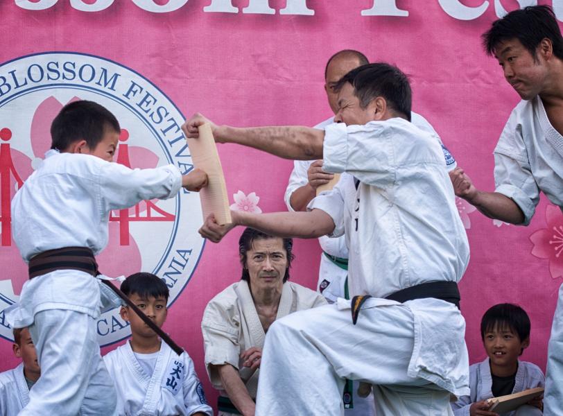 A karate-kid attempts to break a board with his fist at the Cherry Blossom Festival in San Francisco Japantown.  April 13th, 2019.