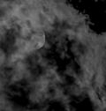 The moon partially obscured by clouds