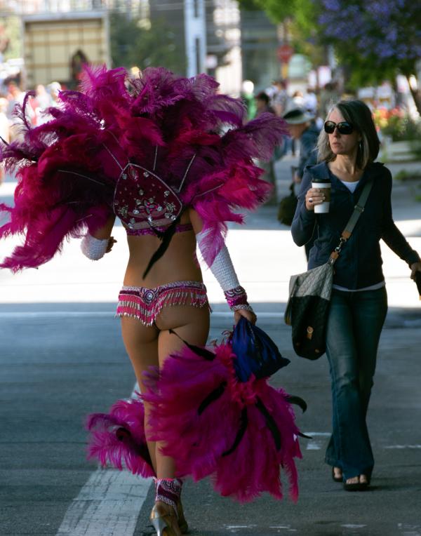 Spectator gives a cool look to a scantily-clad dancer at San Francisco's Carnaval Parade