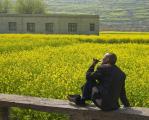 Man smoking his pipe, basking under the sun, Guangxi, China