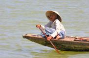 Vietnamese woman paddling on the Perfume River, Hue, Vietnam